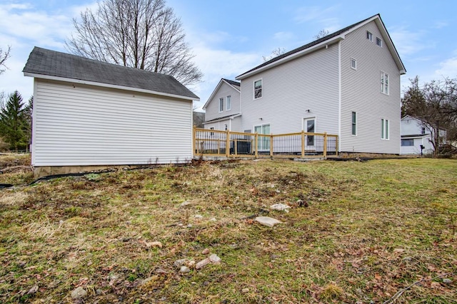 back of house with a lawn and a deck