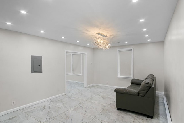 living area with electric panel and an inviting chandelier