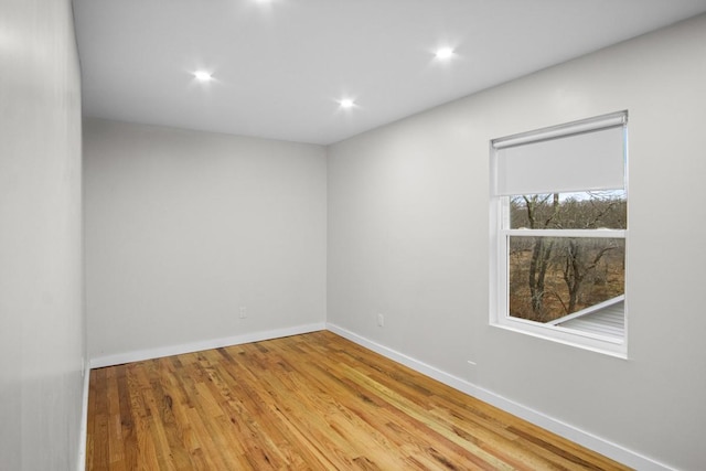 unfurnished room with hardwood / wood-style floors