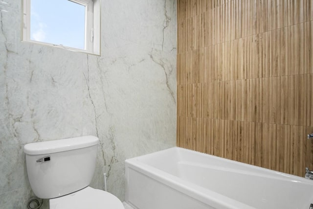 bathroom with toilet and a bathing tub