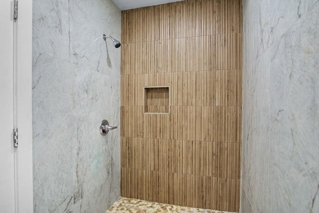 bathroom with tiled shower