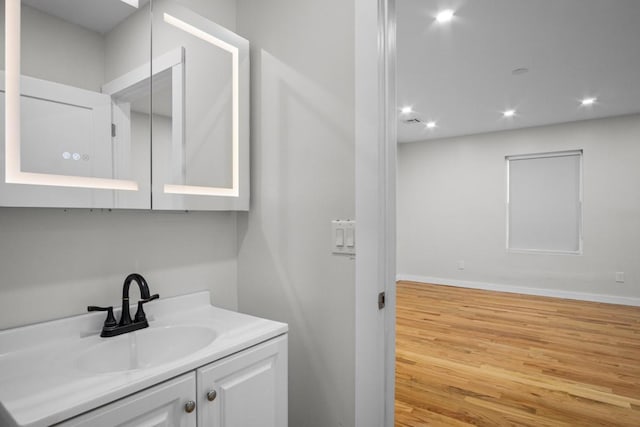 bathroom with vanity and wood-type flooring