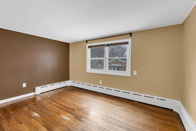 spare room with wood-type flooring