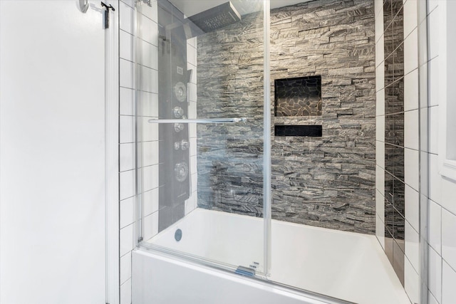 bathroom with shower / bath combination with glass door