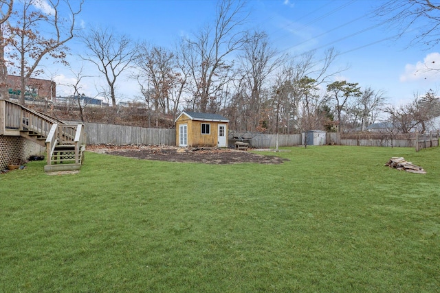 view of yard featuring a deck and a shed