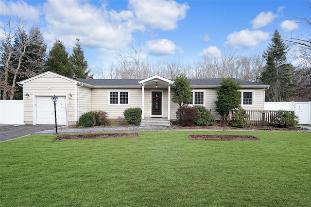 ranch-style home with a garage and a front lawn