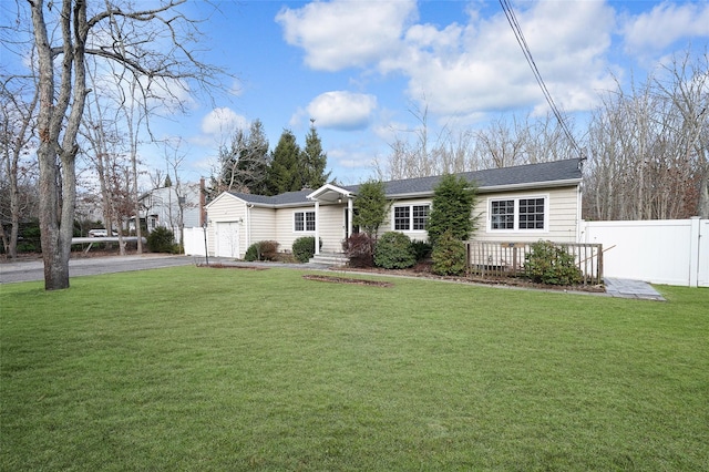 ranch-style house with a front yard and a garage