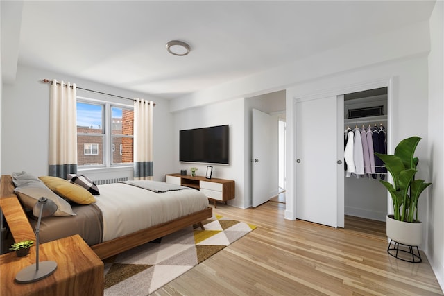 bedroom featuring light hardwood / wood-style floors and a closet