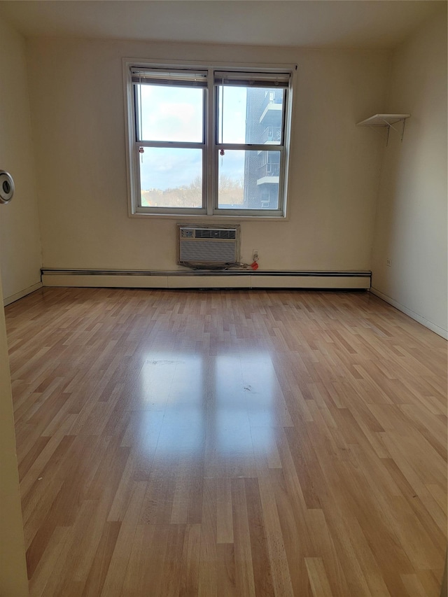 unfurnished room featuring light hardwood / wood-style flooring and a wall mounted air conditioner