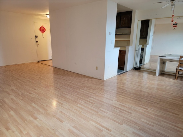 unfurnished room with light hardwood / wood-style flooring and ceiling fan