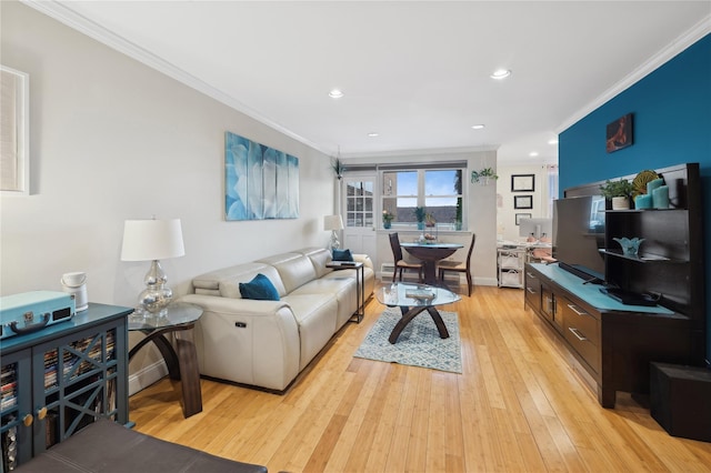 living room with light wood-type flooring and ornamental molding