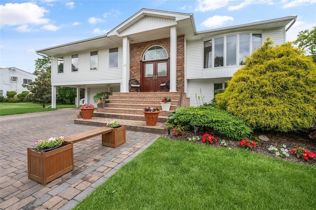 view of front facade with a front yard and french doors