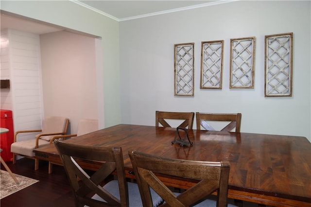 dining space with dark hardwood / wood-style flooring and ornamental molding