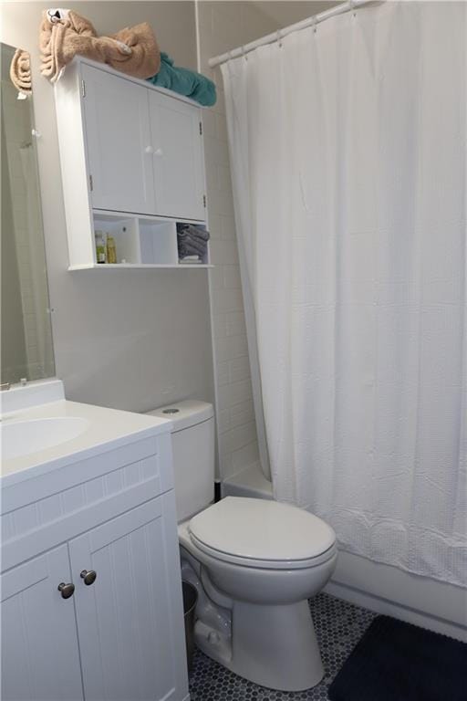 full bathroom featuring tile patterned flooring, vanity, toilet, and shower / bathtub combination with curtain