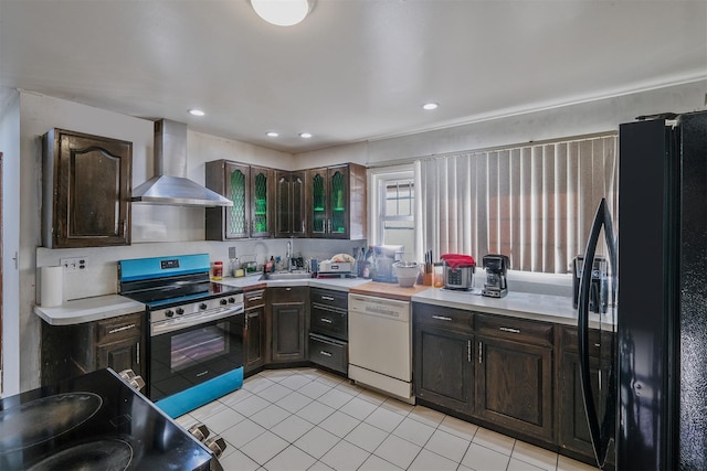 kitchen featuring dark brown cabinetry, wall chimney exhaust hood, electric range oven, refrigerator, and white dishwasher