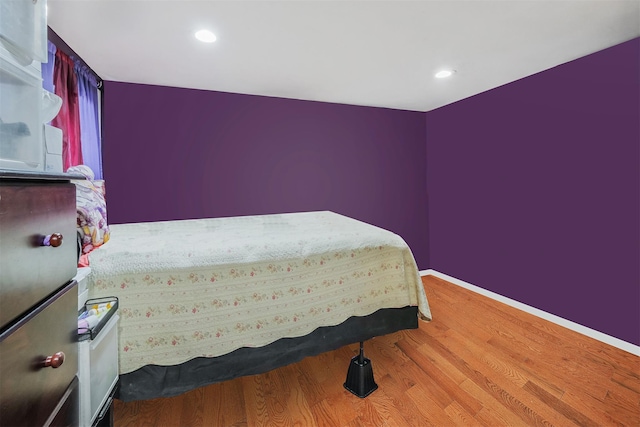 bedroom with hardwood / wood-style floors