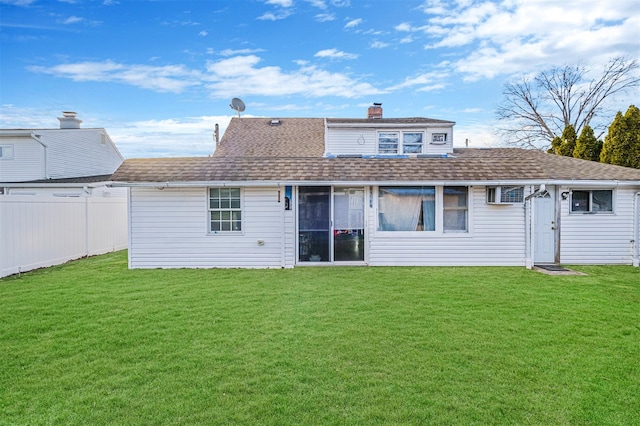 rear view of house featuring a yard