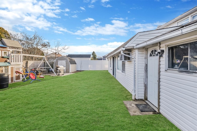 view of yard featuring a playground and a storage unit