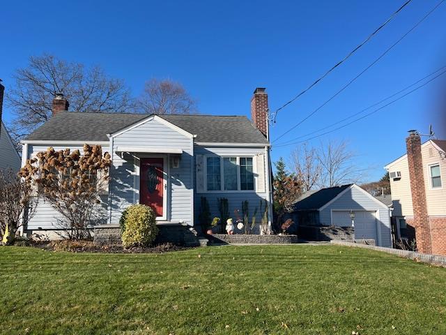 116 Devon Rd, Albertson, NY 11507 - view of front facade featuring an outbuilding and a front lawn