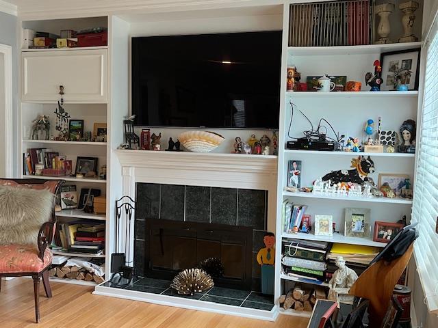 interior space with hardwood / wood-style floors and a fireplace