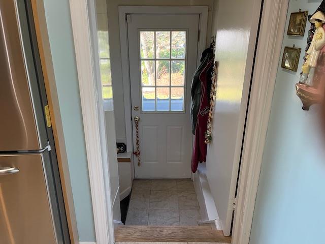 doorway featuring light tile patterned floors