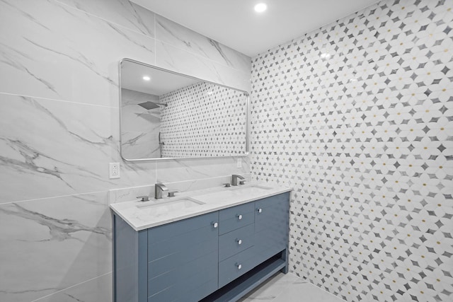 bathroom with vanity and tile walls