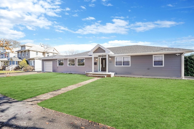 ranch-style house with a front yard and a garage