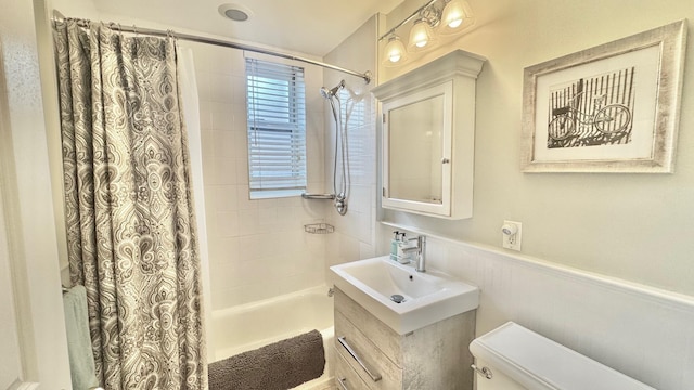 full bathroom with toilet, shower / bathtub combination with curtain, and sink