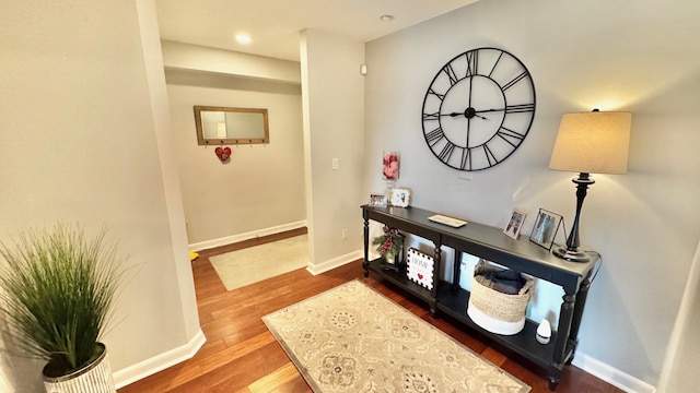 corridor with dark hardwood / wood-style flooring