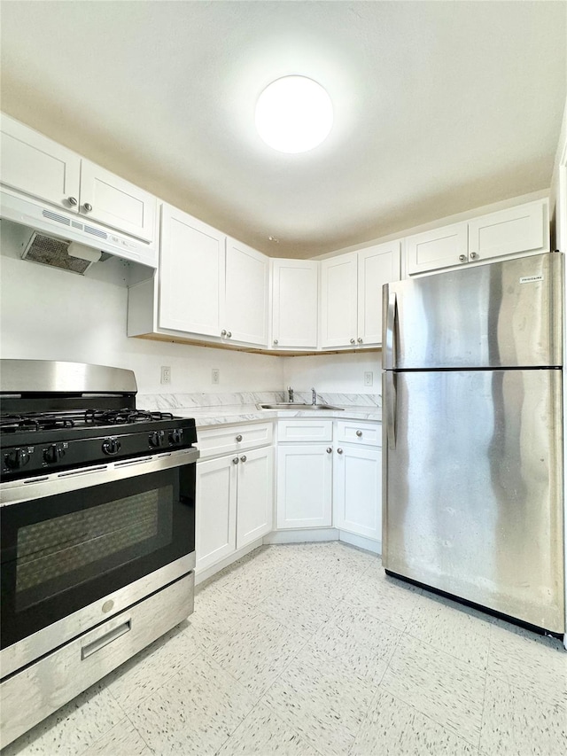 kitchen featuring white cabinets, appliances with stainless steel finishes, and sink