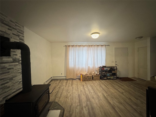 living room with wood-type flooring and a wood stove