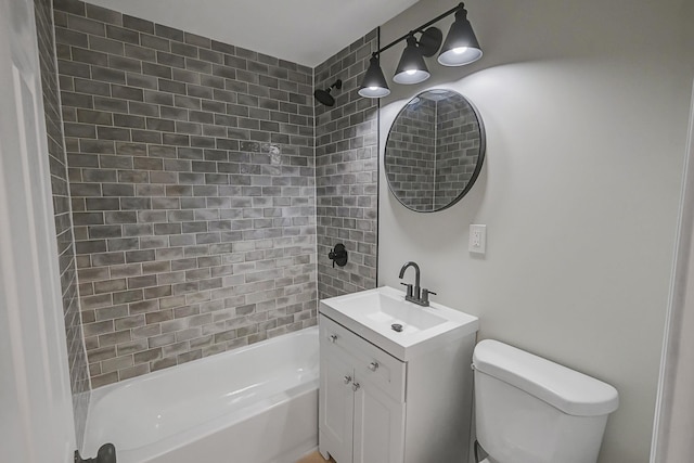 full bathroom featuring toilet, vanity, and tiled shower / bath