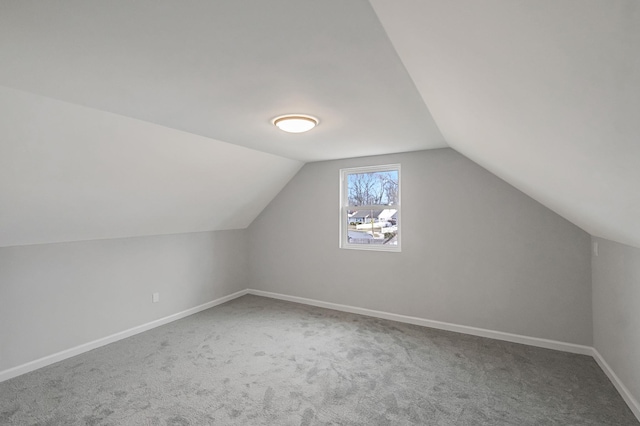 additional living space with carpet and vaulted ceiling