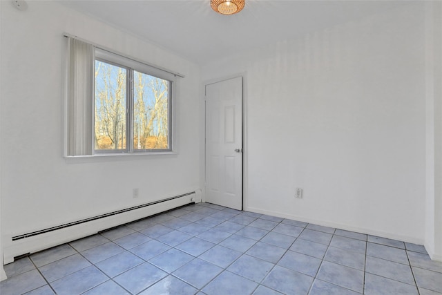 tiled spare room featuring baseboard heating