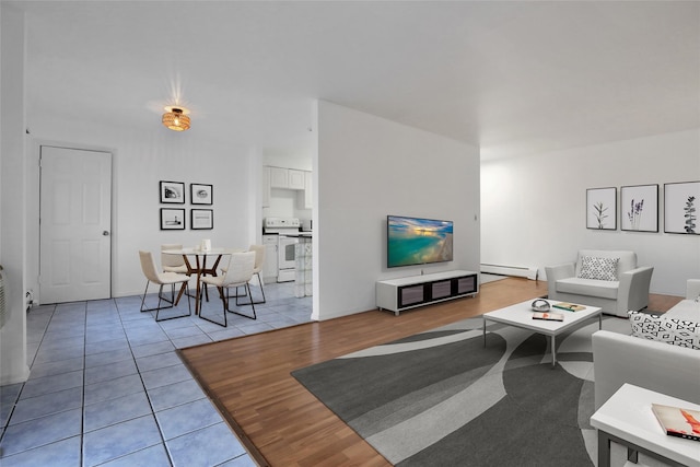 living room featuring light tile patterned floors and baseboard heating