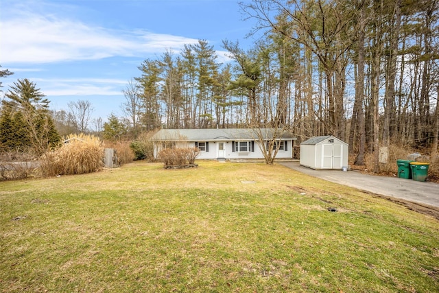 single story home with a front lawn and a storage shed