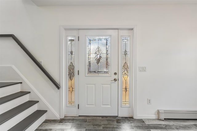 entryway with dark hardwood / wood-style flooring and baseboard heating