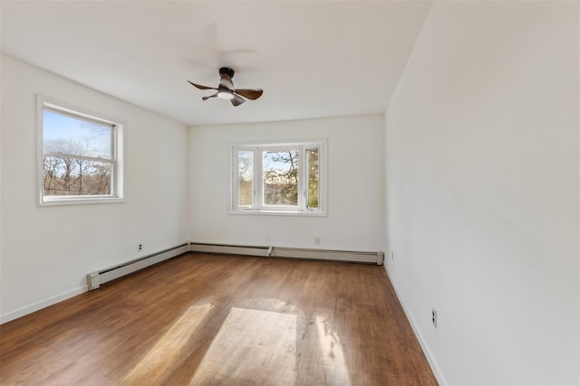 unfurnished room with hardwood / wood-style flooring, ceiling fan, a wealth of natural light, and a baseboard radiator