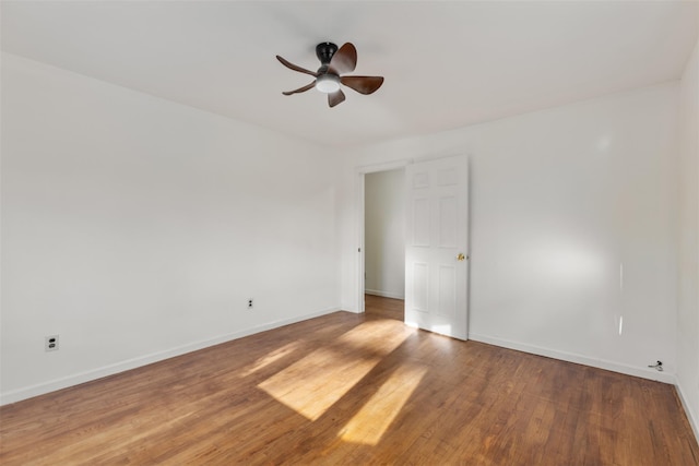 spare room with hardwood / wood-style floors and ceiling fan