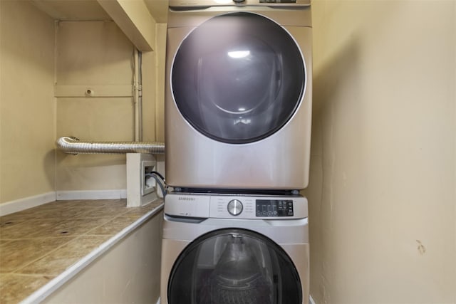 laundry area featuring stacked washer / drying machine