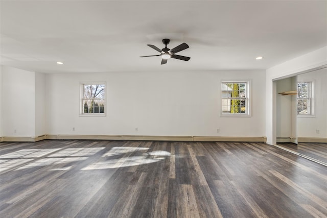 unfurnished room featuring ceiling fan, dark wood-type flooring, and a baseboard radiator