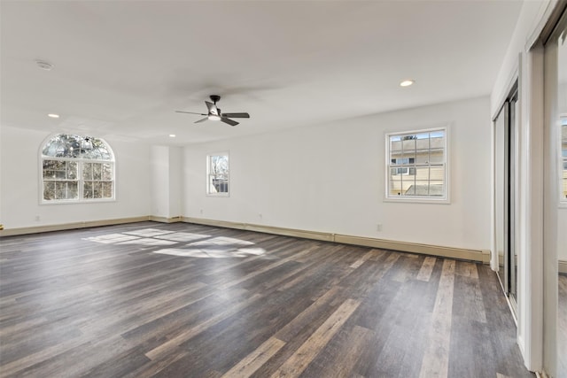 unfurnished bedroom with ceiling fan and dark wood-type flooring