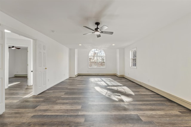 empty room with ceiling fan, baseboard heating, and dark wood-type flooring