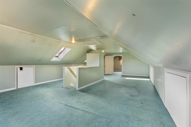 additional living space with light carpet and vaulted ceiling with skylight