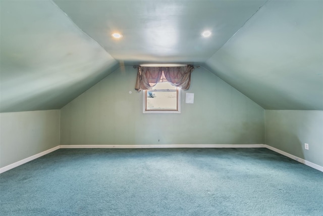 bonus room with carpet flooring and vaulted ceiling