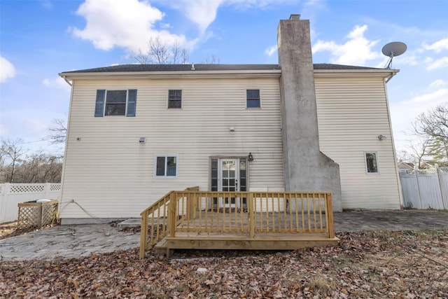 rear view of property featuring a patio and a wooden deck