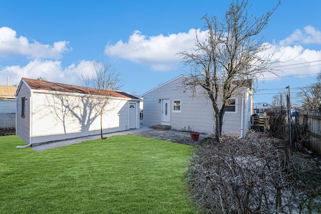 rear view of property with a lawn and a patio