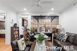 living room with ornamental molding, recessed lighting, ceiling fan, and wood finished floors