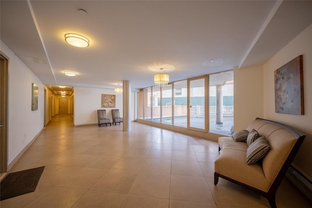 tiled living room featuring an inviting chandelier, expansive windows, a water view, and a baseboard radiator