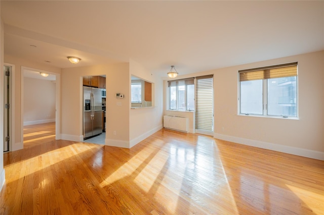 spare room featuring light wood-type flooring